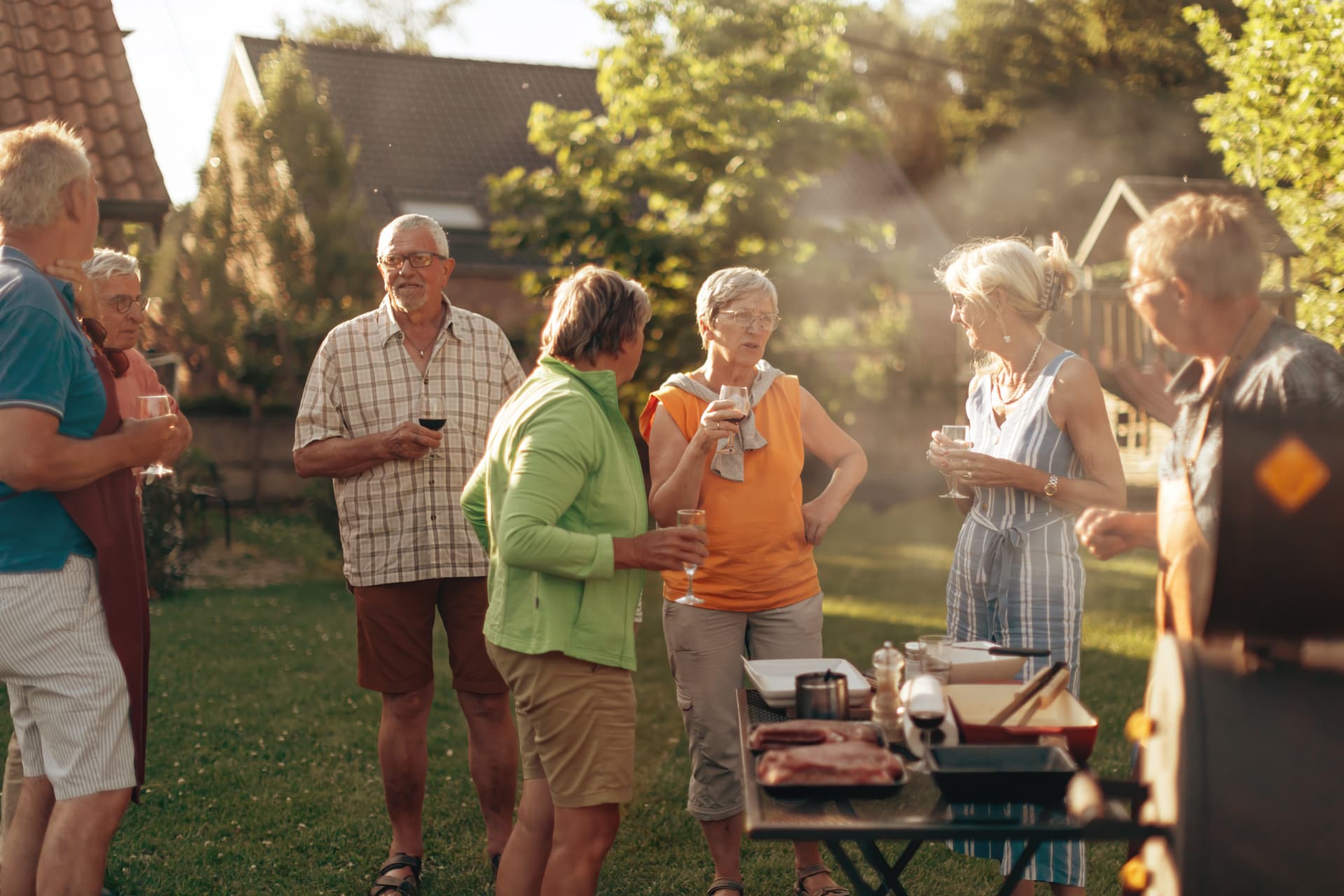 Group of adults gathered outdoors enjoying conversation